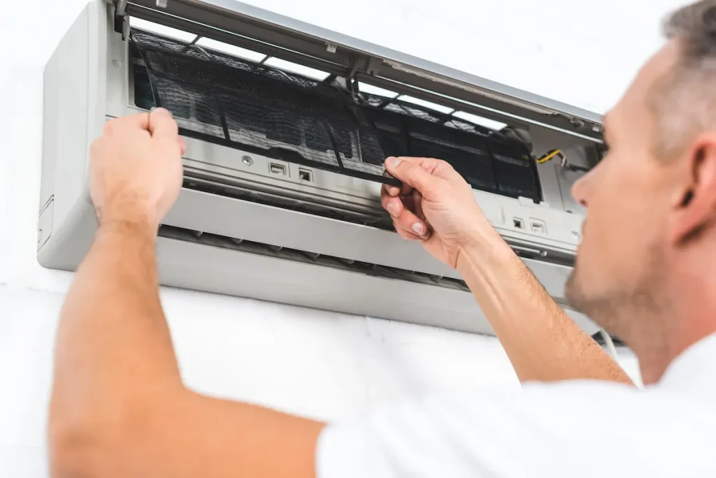 techinician-repairing-an-air-conditioner-filter