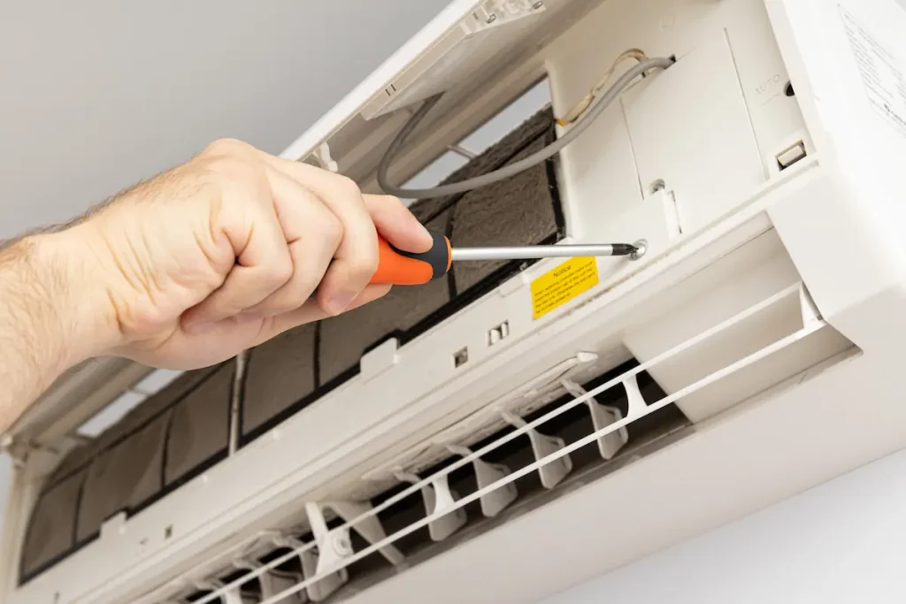 Technician repairing an air conditioner for summer