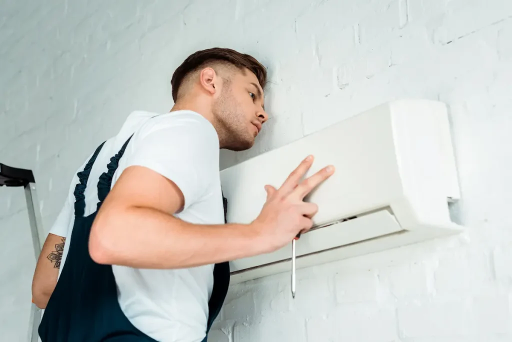 Technician replacing an air conditioning unit