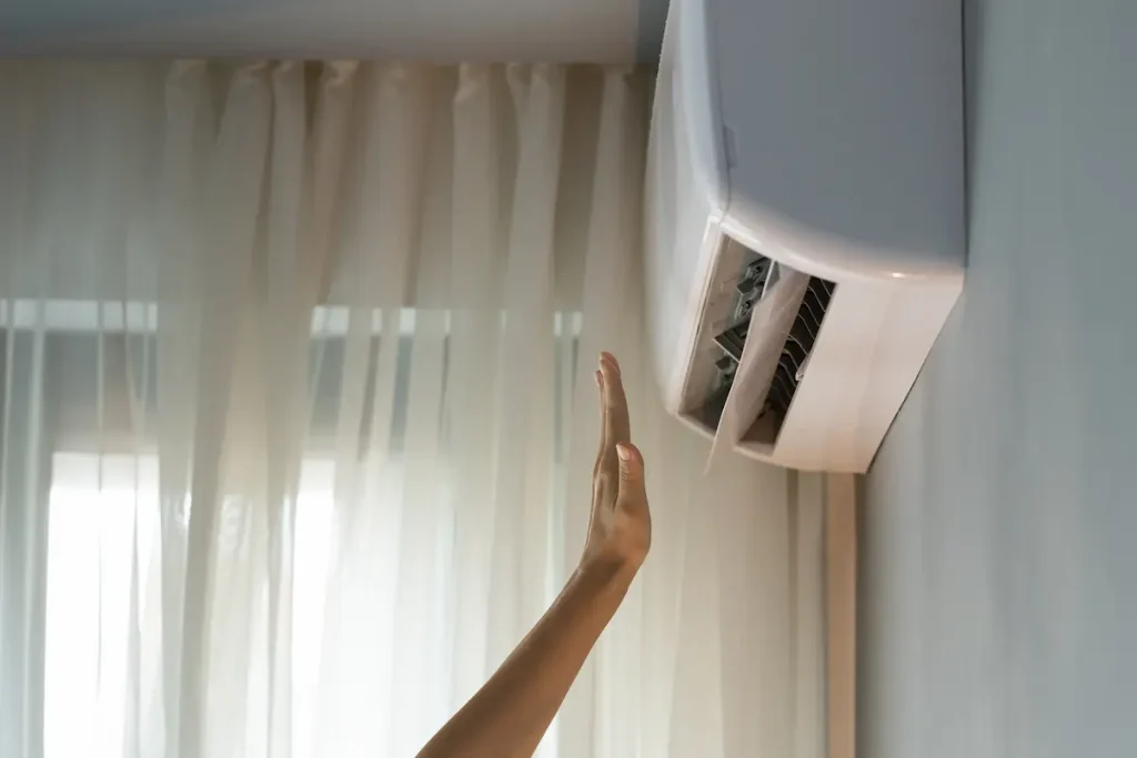Person turning on the air conditioner